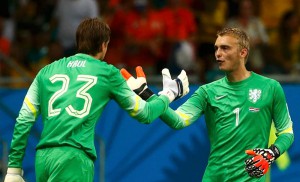 Goalkeeper Tim Krul of the Netherlands goes in for team mate Jasper Cillessen during extra time in their 2014 World Cup quarter-finals against Costa Rica at the Fonte Nova arena in Salvador